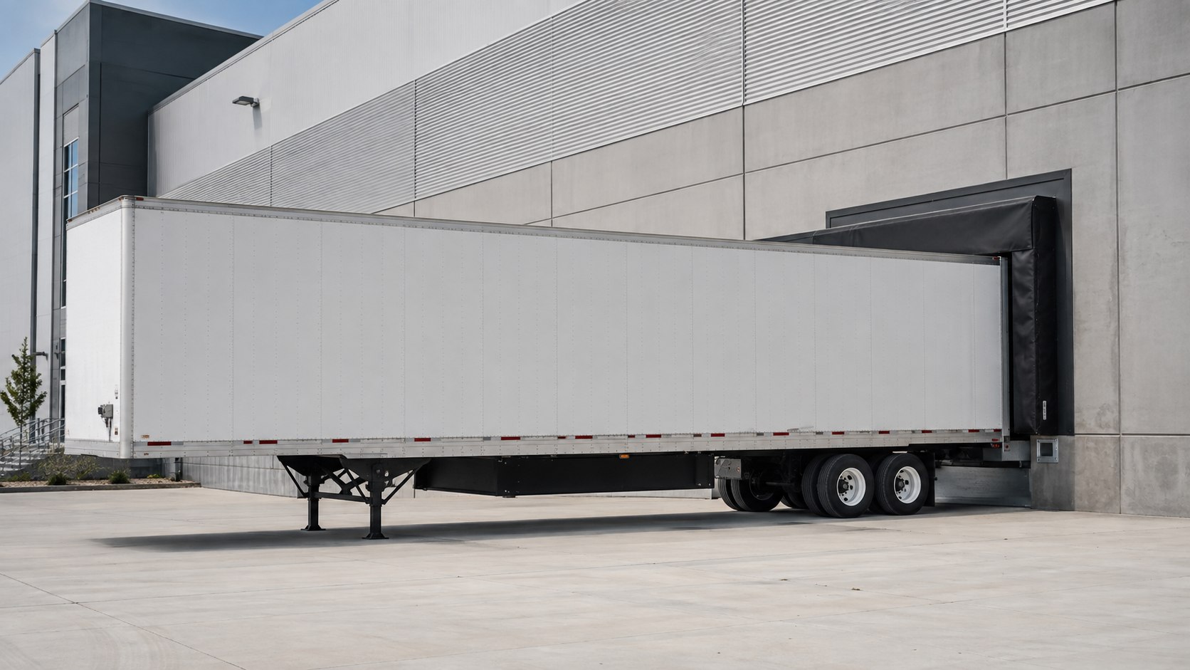 Unbranded freight trailer positioned at a warehouse loading dock